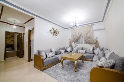 a living room with a couch and a table at Charming and quiet apartment 2 in Marrakech