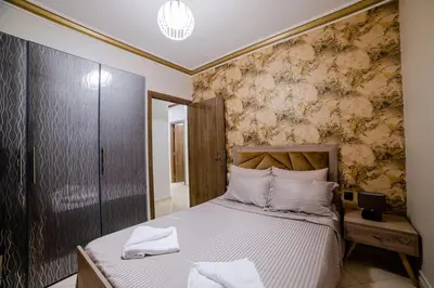 a bedroom with a bed with white pillows at Charming and quiet apartment 2 in Marrakech