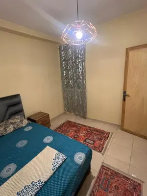 a room with a blue bed and a light at Marrakesh cozy apartment 15mn city center in Marrakech