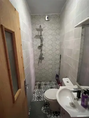 a small bathroom with a toilet and a sink at Marrakesh cozy apartment 15mn city center in Marrakech
