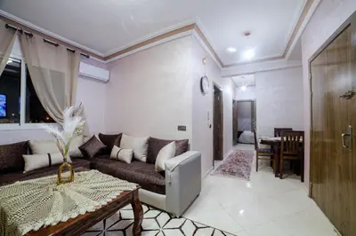 a living room with a couch and a table at Charming and quiet apartment 1 in Marrakech