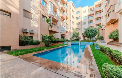 an apartment with a swimming pool in a building at Appartement cosy moderne piscine in Marrakech