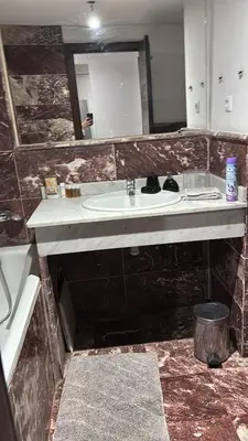 a bathroom with a sink and a mirror at Chez Houda in Marrakech