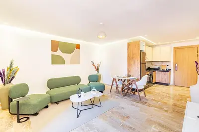 a living room with a couch and a table at Stylish modern 1BR in gueliz in Marrakech