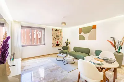a living room with a couch and a table at Stylish modern 1BR in gueliz in Marrakech