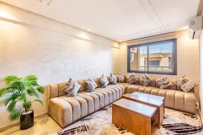 a living room with a couch and a table at 5 Stars Home with Pool & Parking in Marrakech