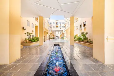 an empty hallway with a fountain in a building at 5 Stars Home with Pool & Parking in Marrakech