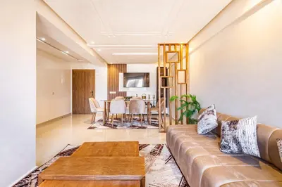 a living room with a couch and a table at 5 Stars Home with Pool & Parking in Marrakech