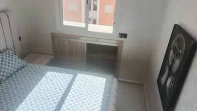 a small bedroom with a bed and a window at marrakech premium village c18 in Marrakech