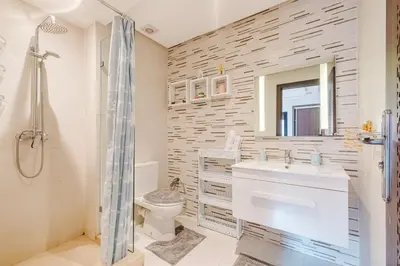 a bathroom with a toilet and a sink and a shower at Luxe 2-Bedroom with Pool in Marrakech in Marrakech