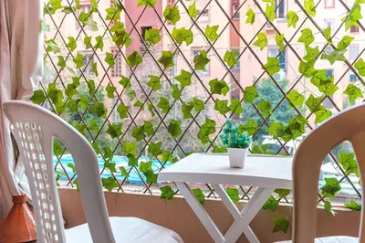 a table and two chairs in front of a window at Luxe 2-Bedroom with Pool in Marrakech in Marrakech