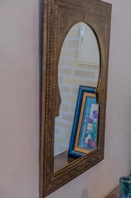 a mirror hanging on a wall with a picture at Chic & spacious apartment in Gueliz in Marrakech
