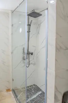 a shower with a glass door in a bathroom at Chic & spacious apartment in Gueliz in Marrakech