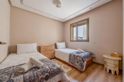a bedroom with two beds and a window at Appartement in Marrakech in Marrakech