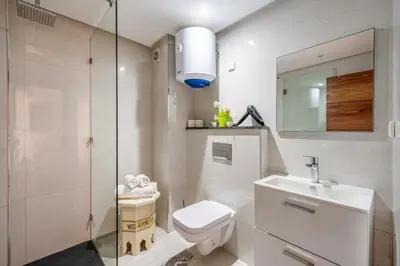 a bathroom with a toilet and a sink and a mirror at Appartement in Marrakech in Marrakech