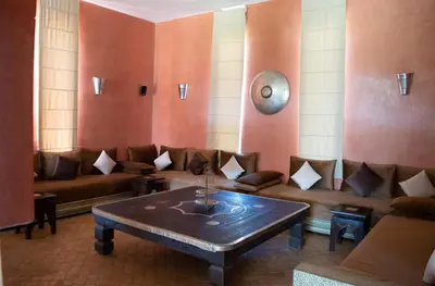 a living room with a couch and a table at Domaine Marradise in Marrakech