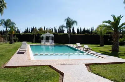 a swimming pool in a yard with a gazebo at Domaine Marradise in Marrakech
