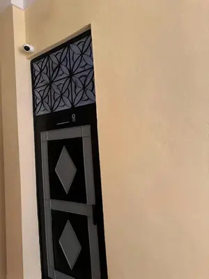 a black door in the corner of a building at Logment cosy in Marrakech