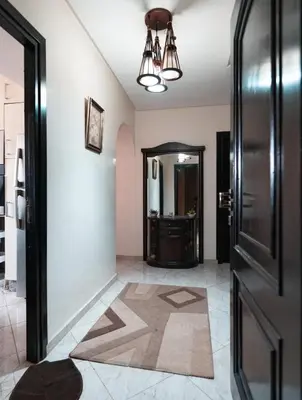 a hallway with a door and a tile floor at La maison du soleil in Oulad Akkou