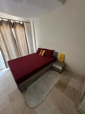 a bedroom with a bed with a large window at Bright & comfortable apartment in Marrakech