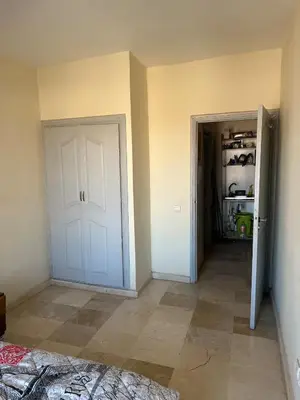 an empty room with a white door and a closet at Bright & comfortable apartment in Marrakech