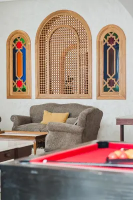 a living room with two couches and a pool table at Dar Saada Private Villa in Marrakech