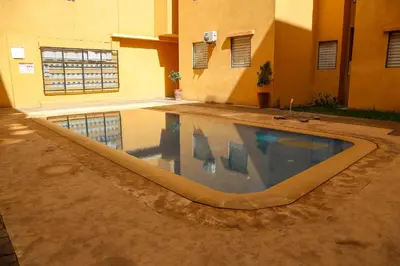 a swimming pool in the middle of a building at Cozy, Nice appartement,swimming pool,Wifi in Marrakech