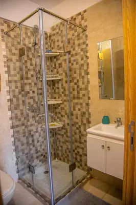 a shower stall in a bathroom with a sink at Cozy, Nice appartement,swimming pool,Wifi in Marrakech