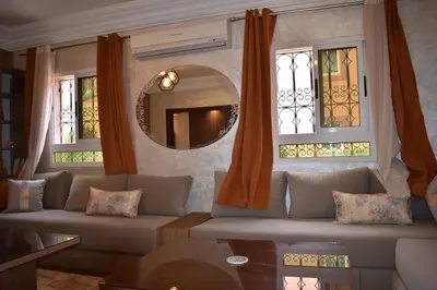 a living room with a couch and two windows at Apartment A Zaitone G5 N3 in Marrakech