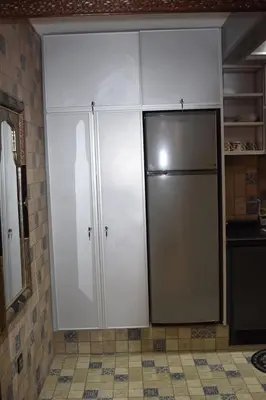 a kitchen with white cabinets and a refrigerator at Apartment A Zaitone G5 N3 in Marrakech