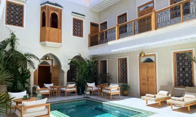a courtyard with a swimming pool in a house at Amanar Marrakech Boutique Hotel & Riad in Marrakech