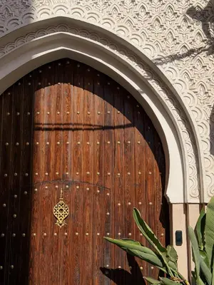 a large wooden door in a building at Amanar Marrakech Boutique Hotel & Riad in Marrakech