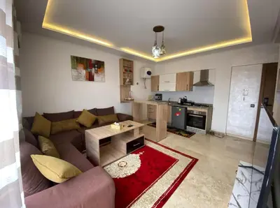 a living room with a couch and a table at LUXURY Apartment Hivernage & Gueliz - Pool, Parking & 24h Security in Marrakech