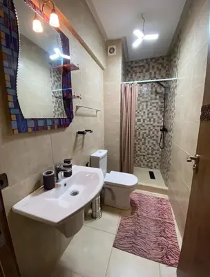 a bathroom with a sink and a toilet and a shower at LUXURY Apartment Hivernage & Gueliz - Pool, Parking & 24h Security in Marrakech