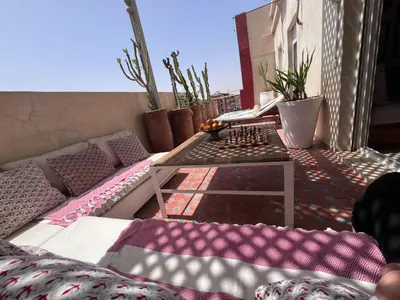 a balcony with a chess board on a table at Rooftop Terrasse - Centre Gueliz in Marrakech