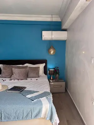 a blue bedroom with a bed with a blue wall at Rooftop Terrasse - Centre Gueliz in Marrakech