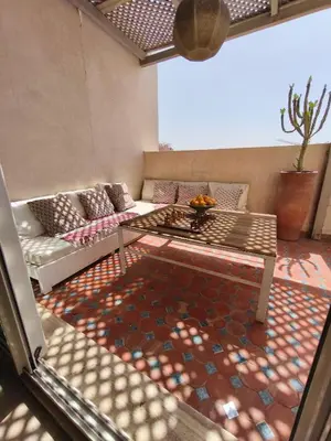 a living room with a couch and a table at Rooftop Terrasse - Centre Gueliz in Marrakech