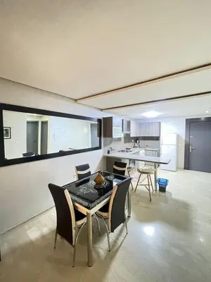 a kitchen and dining room with a table and chairs at Appartement élégant, Escapade parfaite à Marrakech in Marrakech