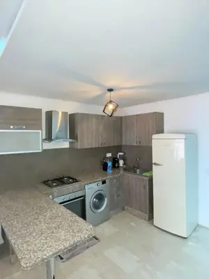a kitchen with a refrigerator and a washing machine at Appartement élégant, Escapade parfaite à Marrakech in Marrakech