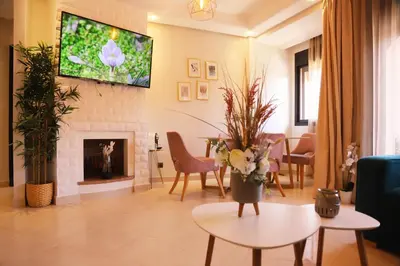 a living room with a fireplace and a tv at Charming apartment in a tourist village Premium village in Marrakech