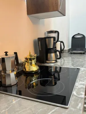a kitchen counter with a coffee maker and tea pots at Luxuriöse Wohnung mit Pool und Netflix in Marrakech