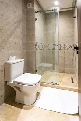 a bathroom with a toilet and a shower at Modern Apartment in Victor Hugo Walk to Gueliz City Center in Marrakech