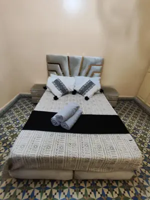 a bed with two pillows on it in a room at Étoile de fatima - au cœur de la médina in Marrakech