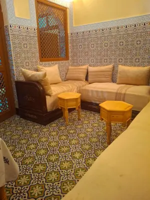 a living room with a couch and two tables at Étoile de fatima - au cœur de la médina in Marrakech