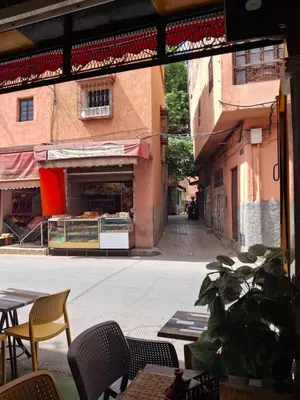 a view of an empty street with tables and chairs at Étoile de fatima - au cœur de la médina in Marrakech