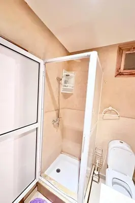 a small bathroom with a toilet and a shower at Central Gueliz Apartment Bright & Peaceful in Marrakech