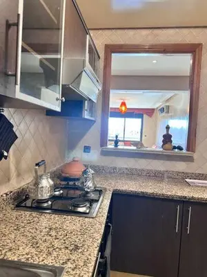 a kitchen with a stove and a sink and a mirror at Central Gueliz Apartment Bright & Peaceful in Marrakech