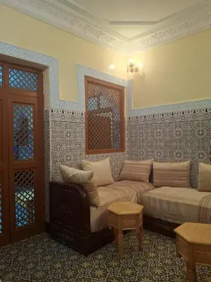 a living room with a couch and a table at Lalla Fatima - a deux pas de la Bahia in Marrakech