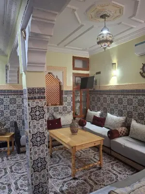 a living room with a couch and a table at Lalla Fatima - a deux pas de la Bahia in Marrakech