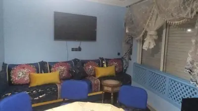 a living room with a couch and a flat screen tv at appartement marrakech Gueliz in Marrakech